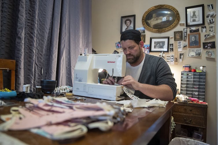 A man with a sewing machine.