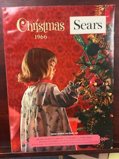 Catalogue cover showing child looking at a Christmas tree.