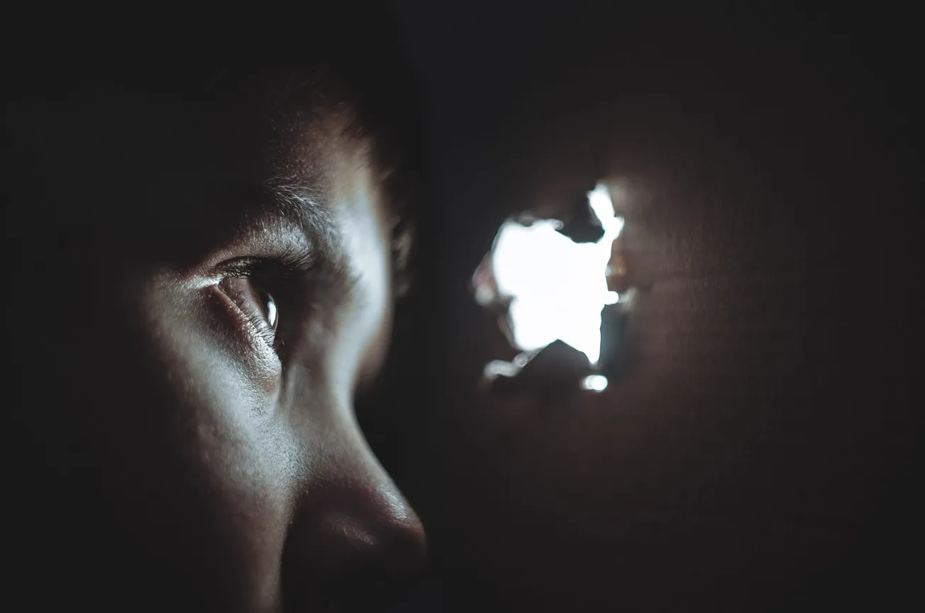 person watching through hole