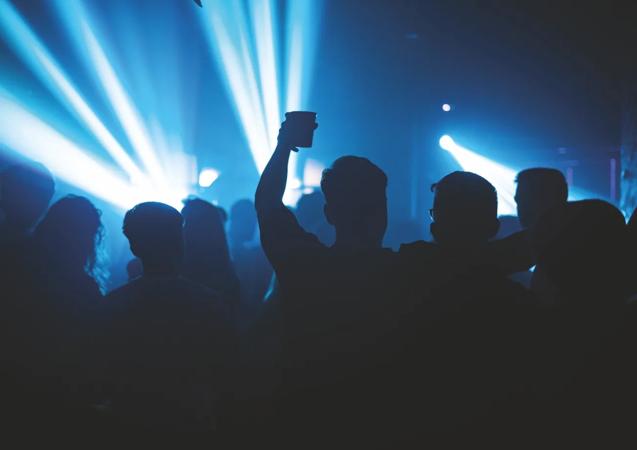 silhouette of people standing and raising hands