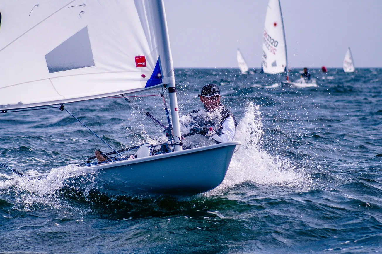 man riding sailboat