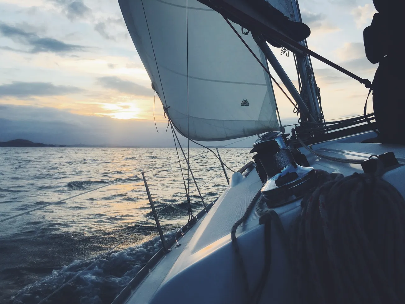 white sailing boat on body of water