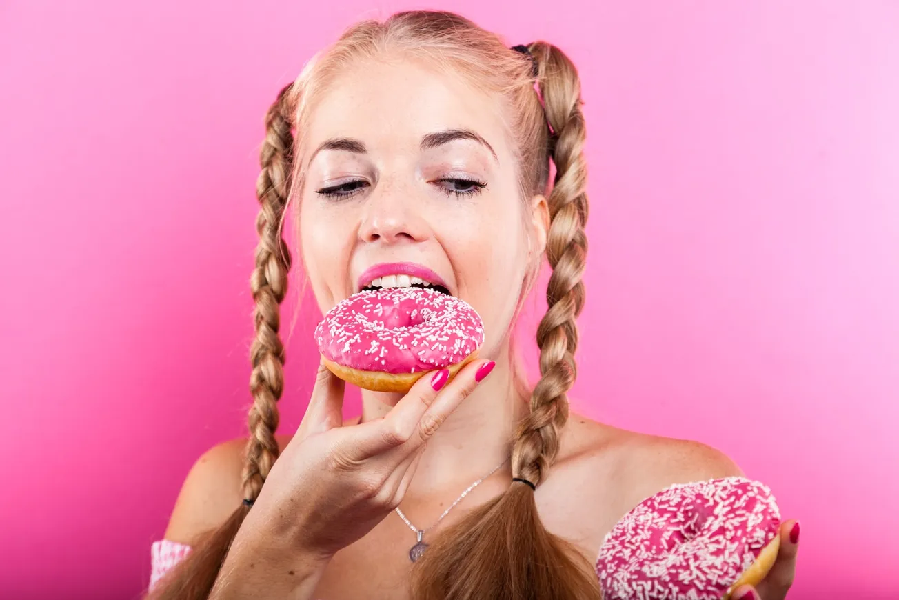 woman in pink and white floral top holding ice cream