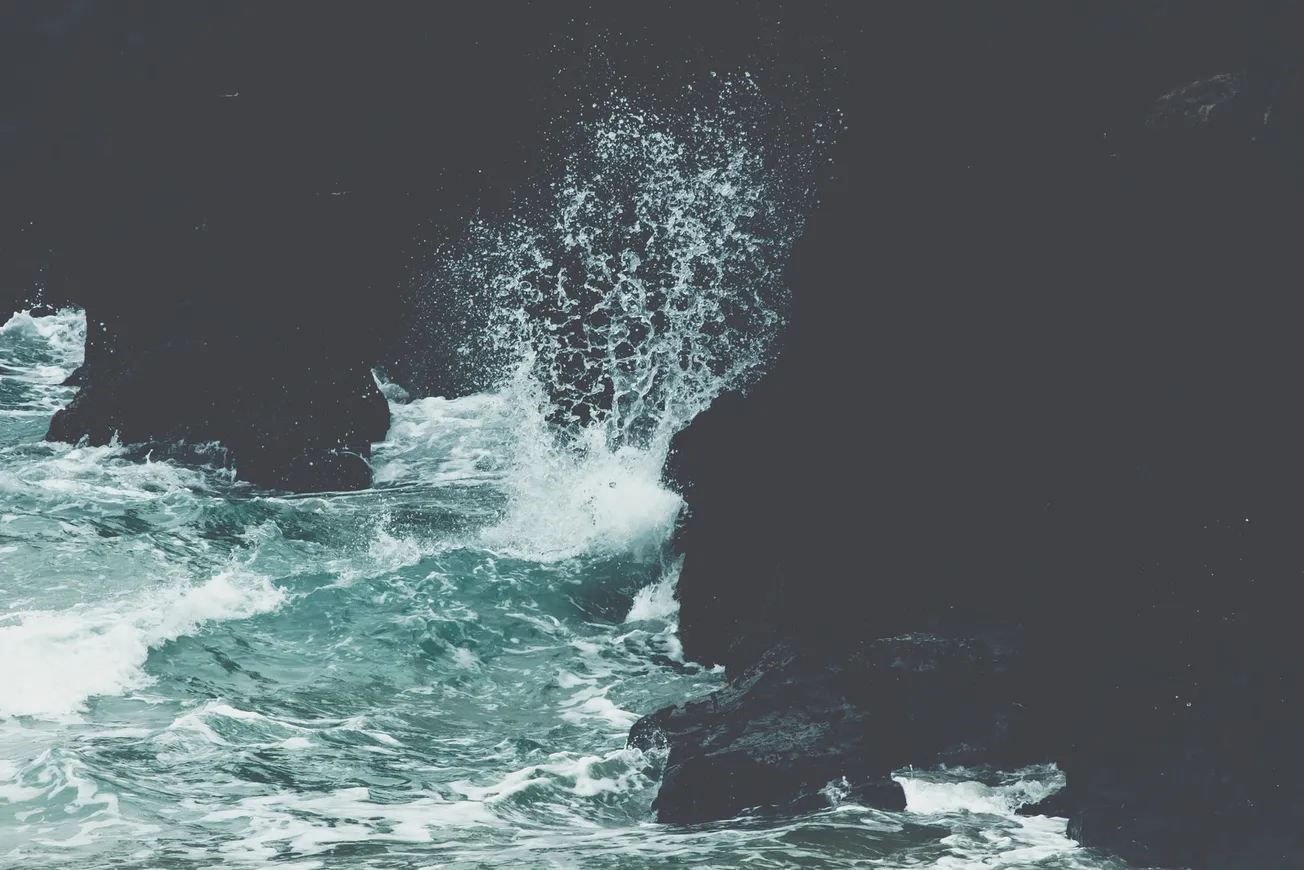 sea waves crashing on rocks