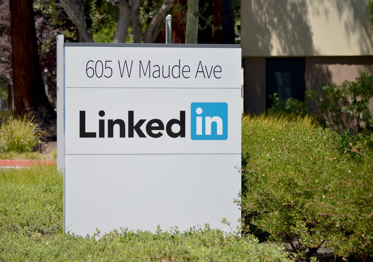 brown wooden signage on green grass field