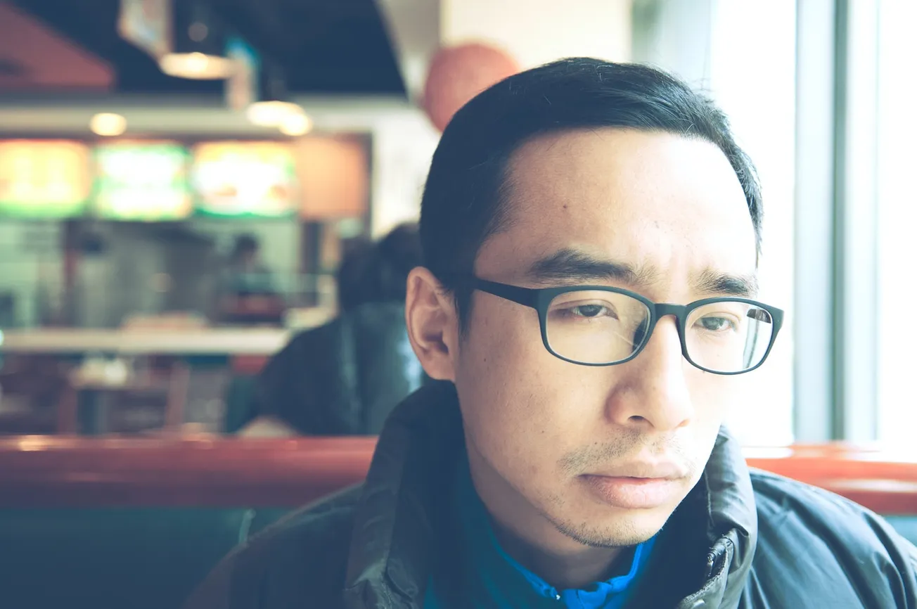 man in black framed eyeglasses and black jacket