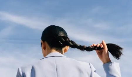 Woman in Light Blue Blazer Holding her Hair