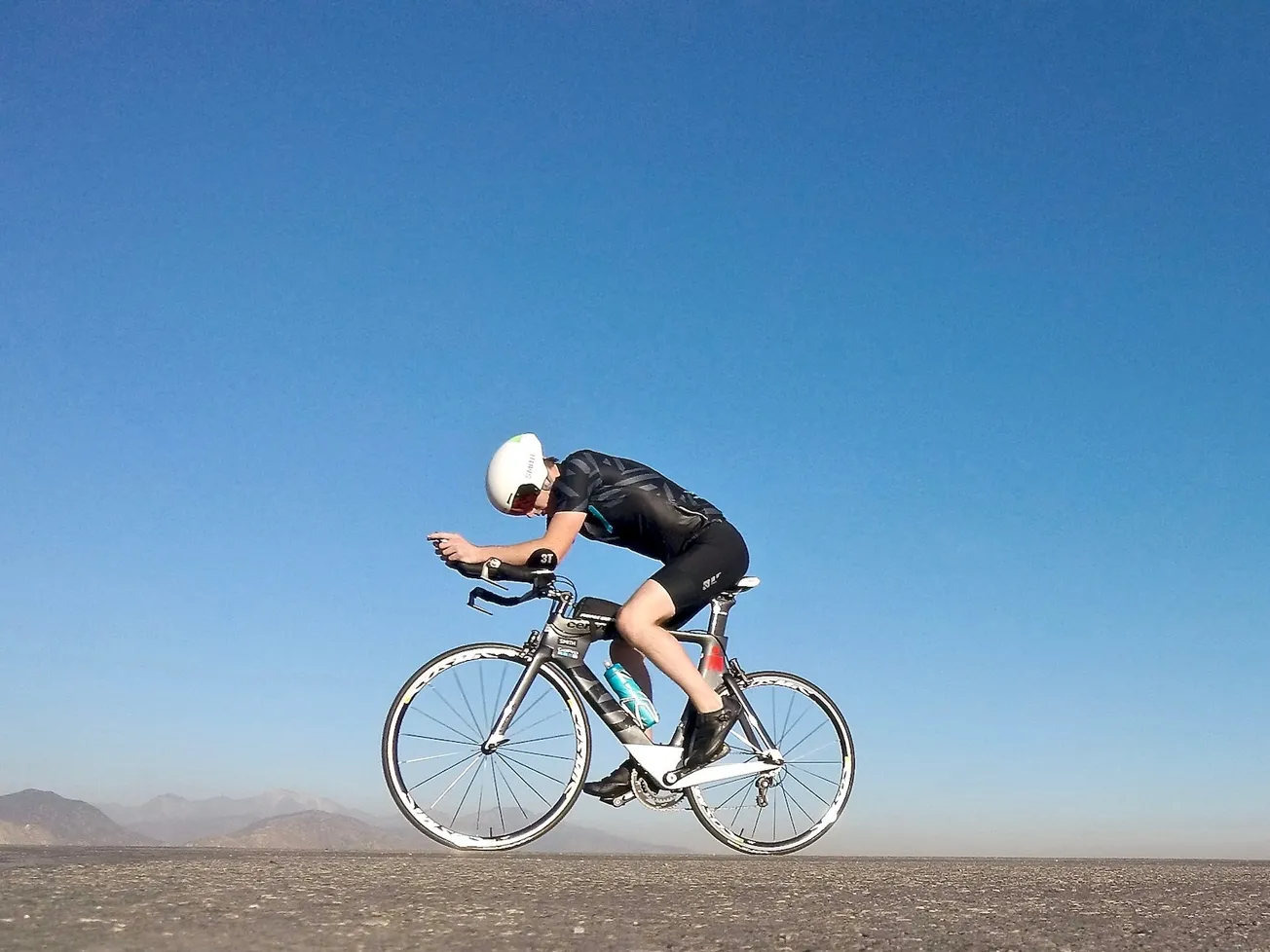 man riding on gray road bicycle during daytime