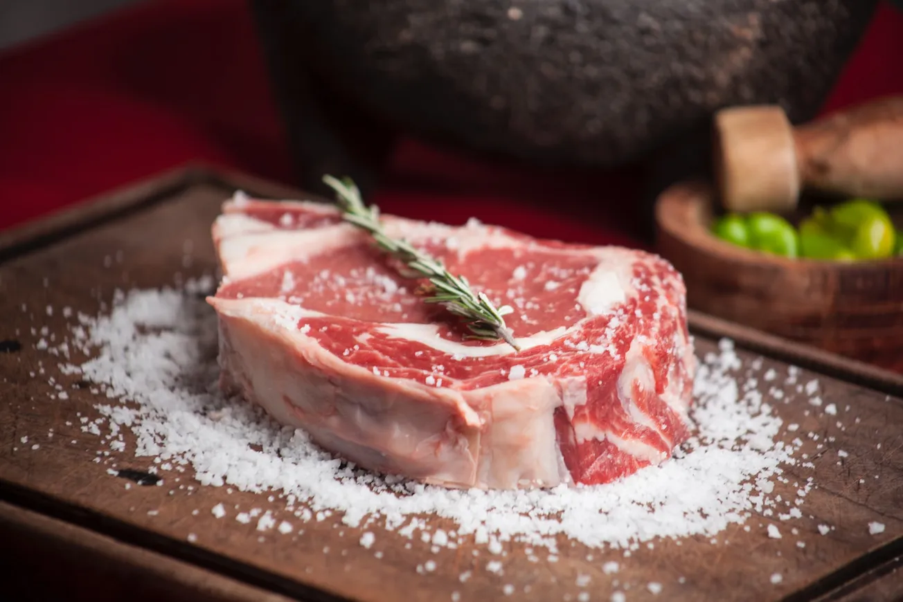 raw meat on brown wooden chopping board