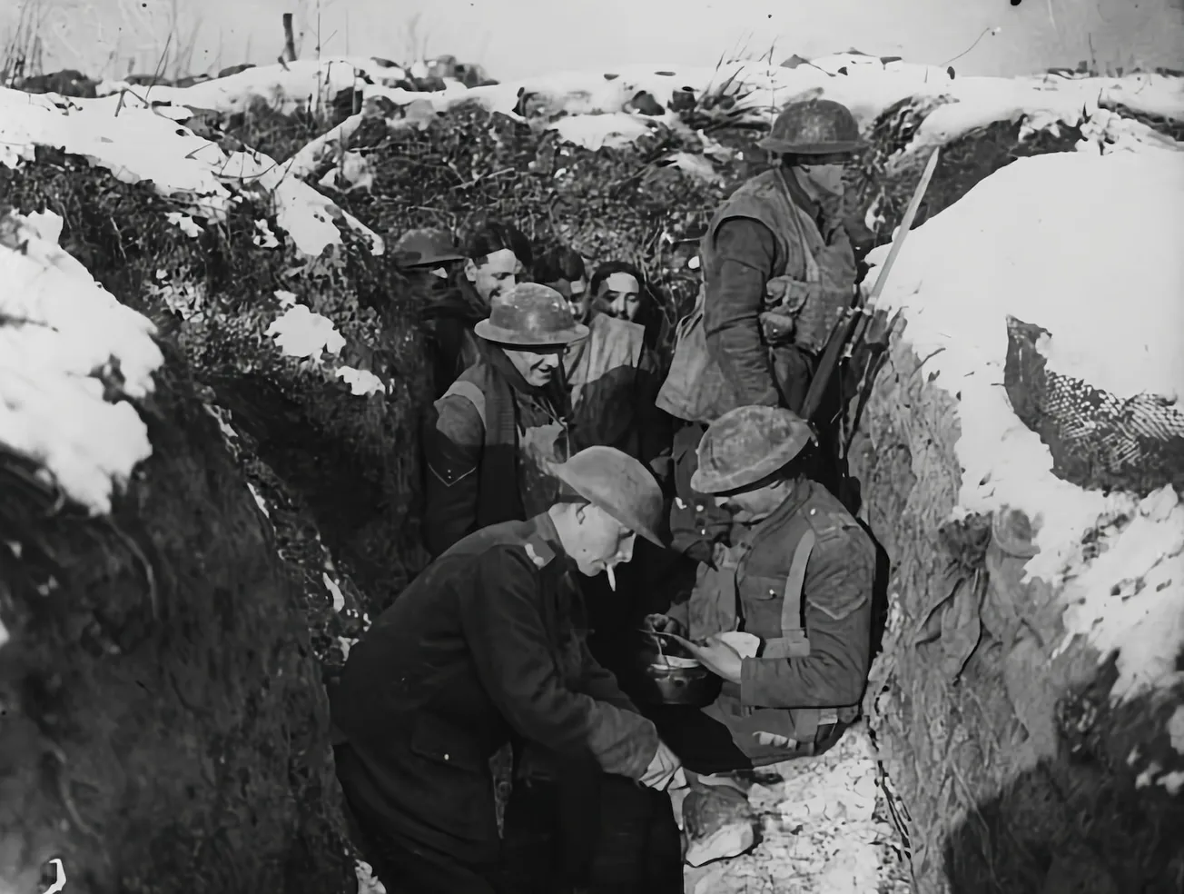 a group of men standing next to each other in the snow