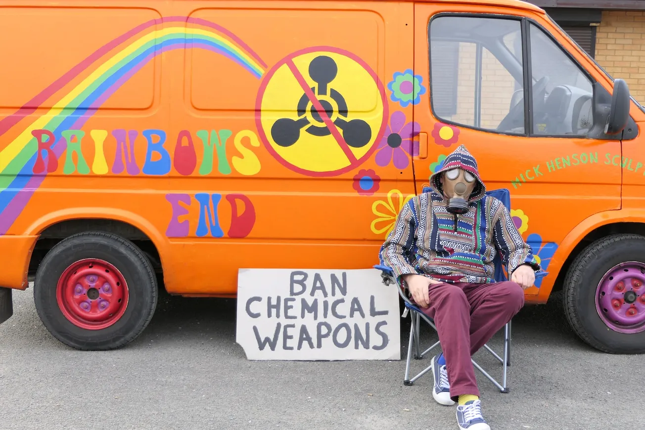 a man sitting in a chair next to a van