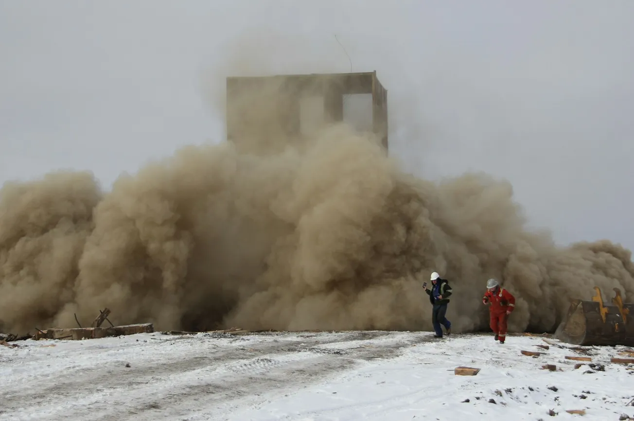 a group of people standing on top of a snow covered slope