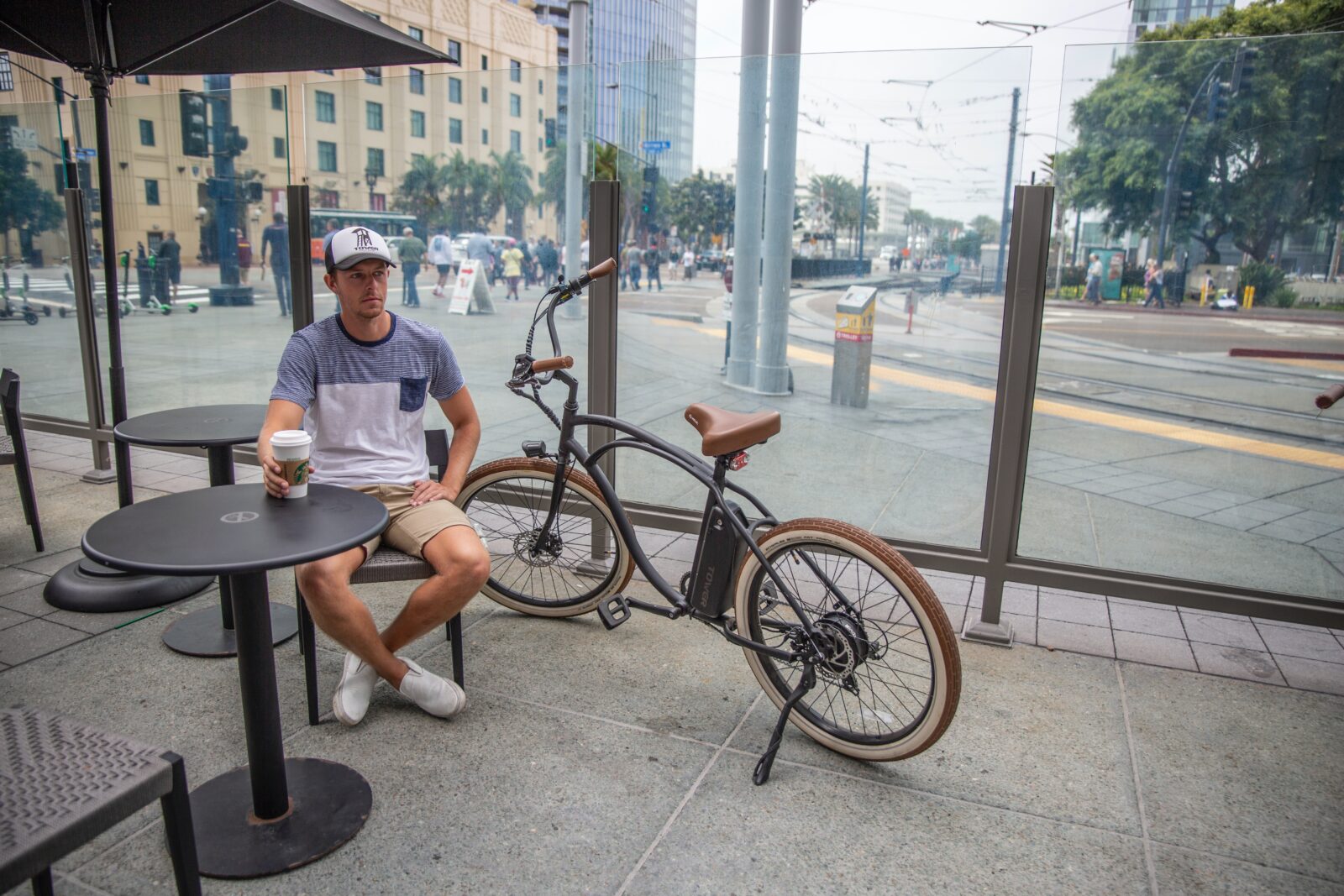 man in white crew neck t-shirt sitting on black chair